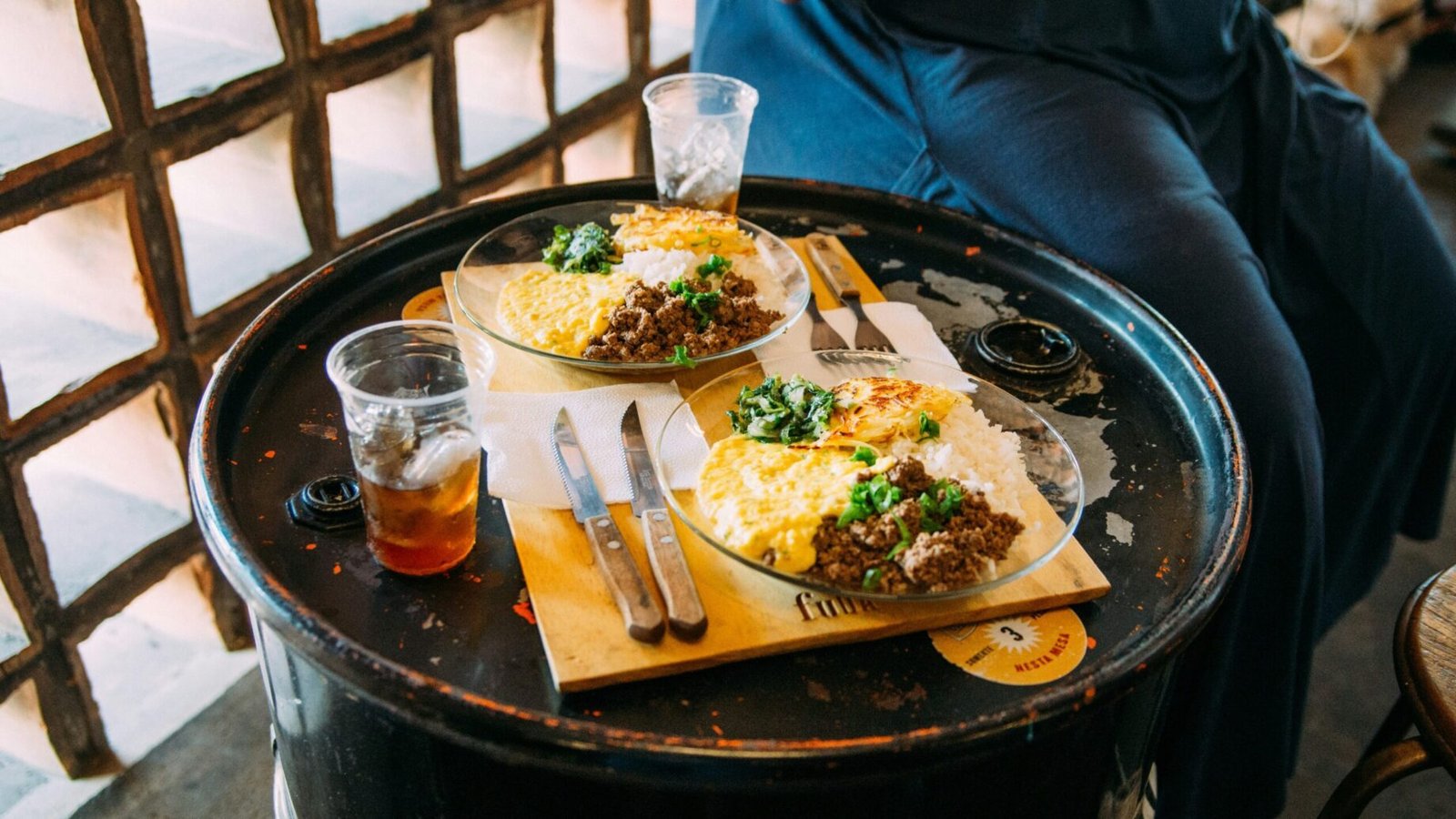 a person sitting at a table with food on it