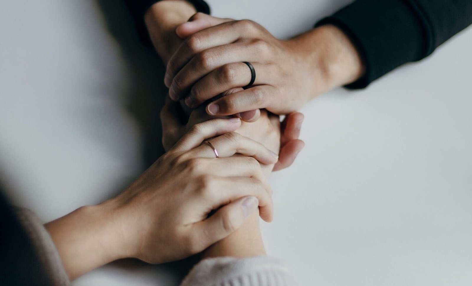 person in black long sleeve shirt holding babys feet